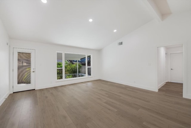 unfurnished living room with lofted ceiling with beams and wood-type flooring