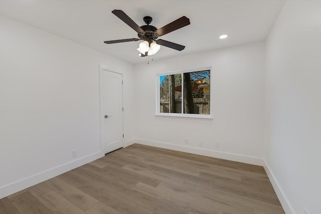 empty room with ceiling fan and light wood-type flooring