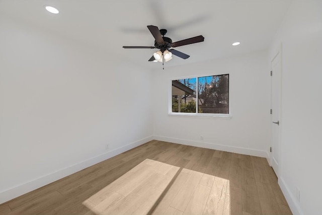 empty room with light wood-type flooring and ceiling fan