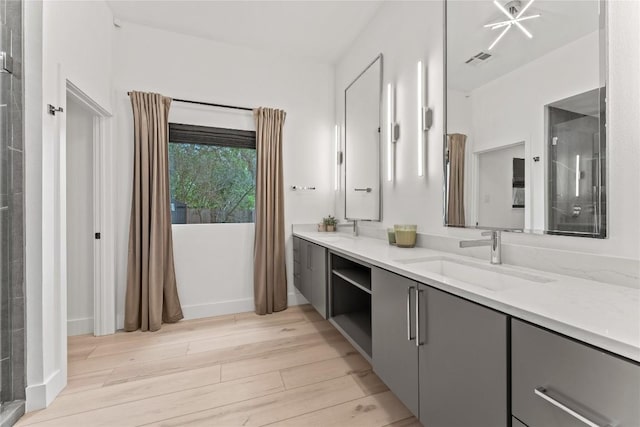 608 Whispering Oaks Dr, Salado, TX 76571 - full bath featuring wood finished floors, double vanity, a shower, and baseboards