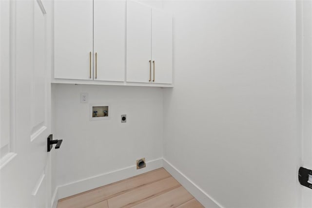 laundry area featuring washer hookup, cabinet space, light wood-style floors, hookup for an electric dryer, and baseboards