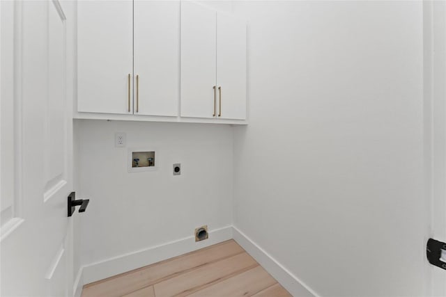 608 Whispering Oaks Dr, Salado, TX 76571 - laundry area featuring hookup for an electric dryer, cabinet space, washer hookup, light wood-style floors, and baseboards