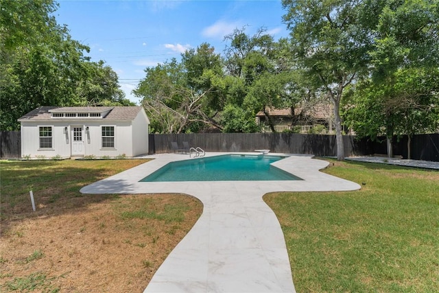 view of pool featuring a storage structure, a yard, a fenced backyard, and an outbuilding