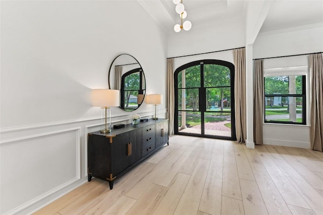 608 Whispering Oaks Dr, Salado, TX 76571 - entryway featuring light wood-type flooring, ornamental molding, and a wainscoted wall