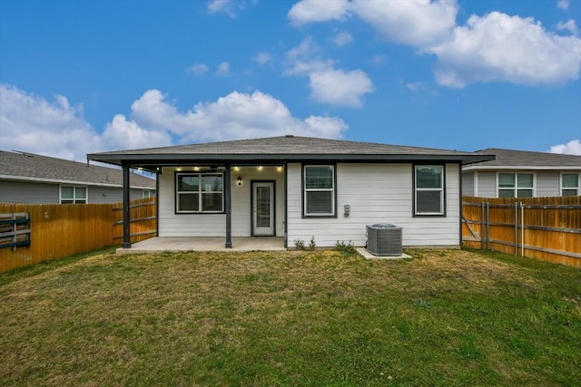 back of house with a patio, a yard, and central AC unit