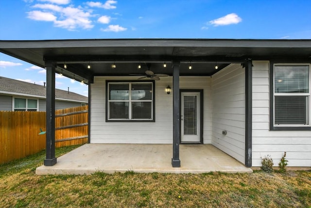 back of house featuring ceiling fan, a yard, and a patio