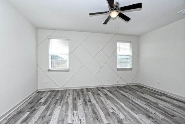 empty room featuring hardwood / wood-style flooring and ceiling fan