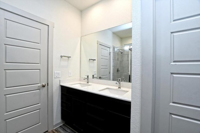 bathroom featuring vanity, a shower with door, and wood-type flooring