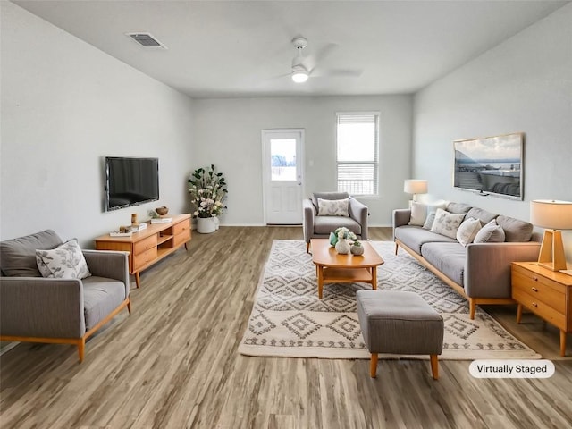 living room featuring hardwood / wood-style floors and ceiling fan