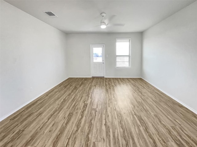 spare room with ceiling fan and wood-type flooring