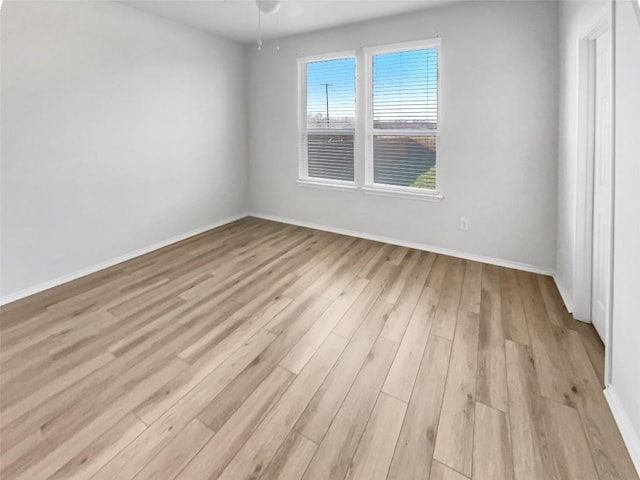 unfurnished room featuring ceiling fan and light hardwood / wood-style flooring