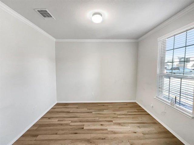 unfurnished room with crown molding and light hardwood / wood-style flooring