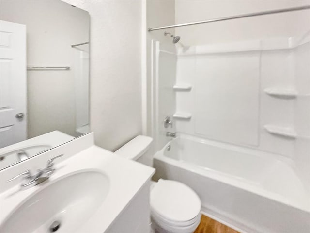 full bathroom with toilet, tub / shower combination, sink, and hardwood / wood-style floors