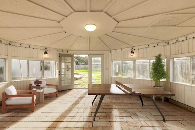 sunroom featuring lofted ceiling