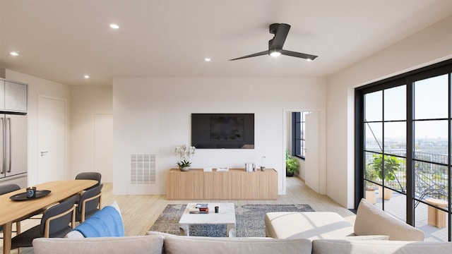 living room with light hardwood / wood-style floors and ceiling fan