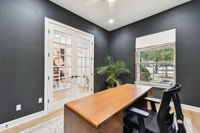 office area featuring french doors, ceiling fan, and light wood-type flooring