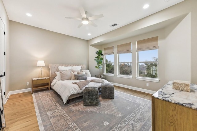 bedroom with hardwood / wood-style floors and ceiling fan