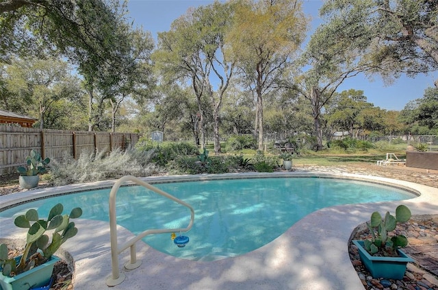 view of pool with a fenced in pool and fence