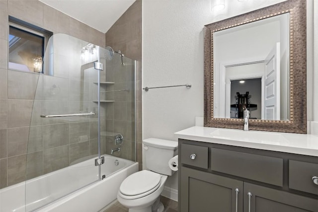 full bathroom with bath / shower combo with glass door, vanity, and toilet