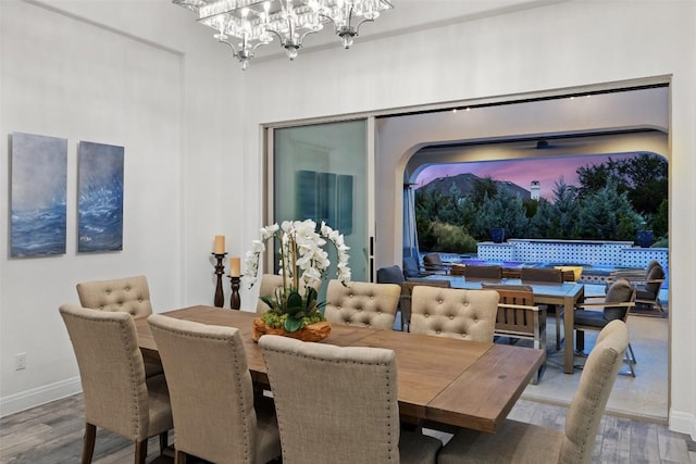 dining room featuring wood-type flooring and a chandelier