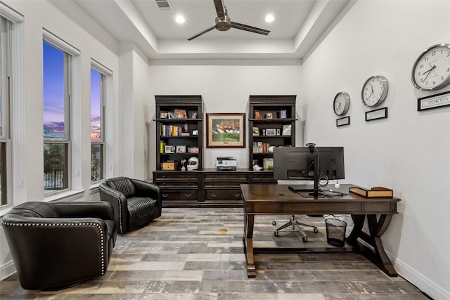 home office featuring hardwood / wood-style floors and ceiling fan