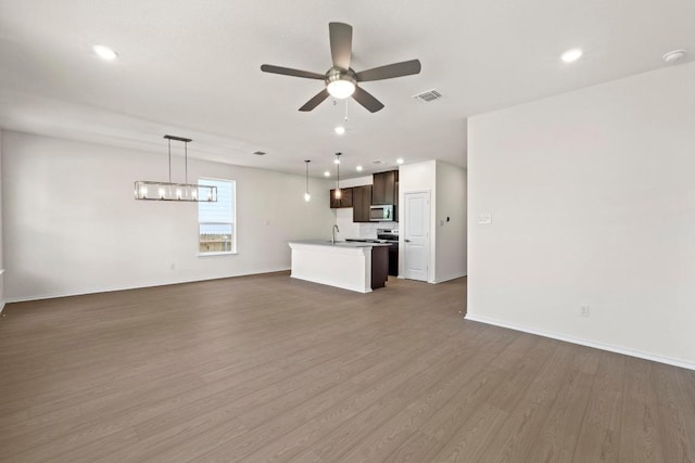 19216 Lady Bird Johnson St, Manor, TX 78653 - unfurnished living room with ceiling fan, dark wood-style floors, and recessed lighting