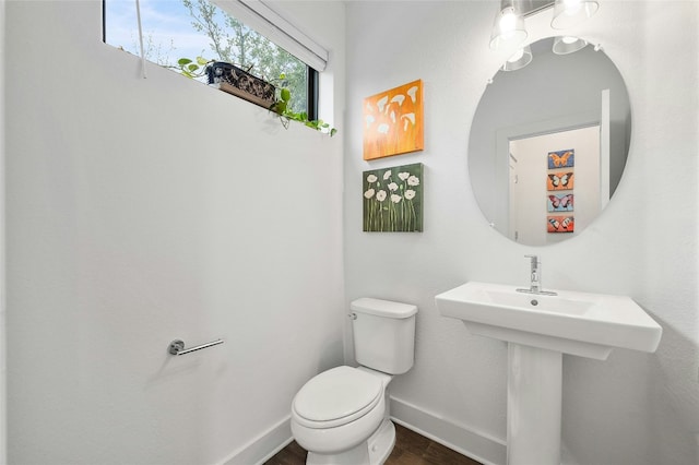 2050 Lohmans Spur Rd Unit 101, Lakeway, TX 78734 - half bathroom featuring baseboards, wood finished floors, and toilet