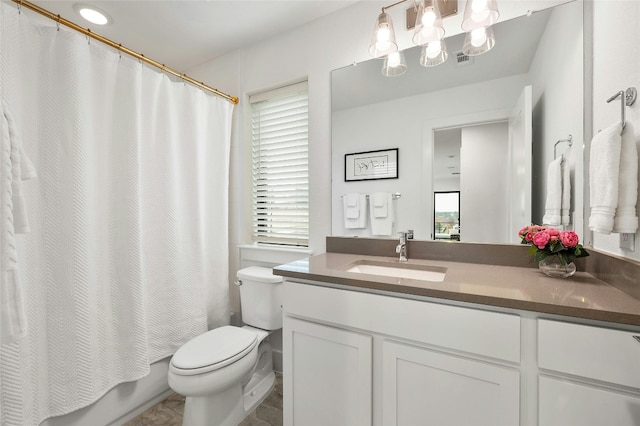 full bathroom with vanity, shower / bath combo with shower curtain, and toilet