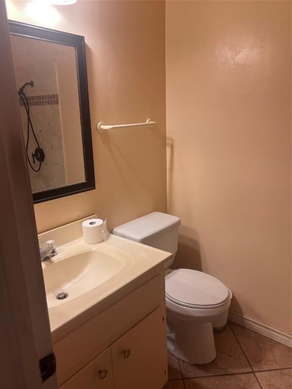 bathroom with vanity, toilet, and tile patterned flooring