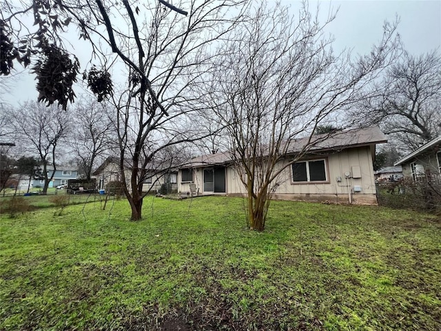 rear view of property with a lawn