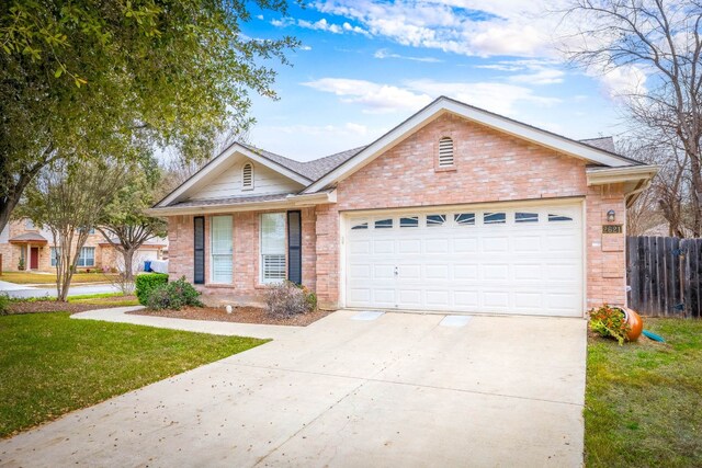 2621 Dove Crossing Dr, New Braunfels, TX 78130 - single story home with fence, an attached garage, driveway, a front yard, and brick siding