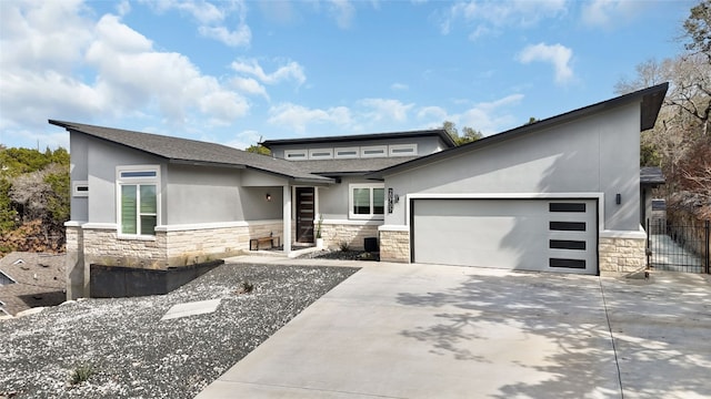 view of front of house featuring stone siding, concrete driveway, an attached garage, and stucco siding