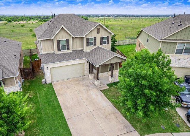 237 Andele Way, Liberty Hill, TX 78642 - view of front of home with a shingled roof, driveway, a garage, and stone siding