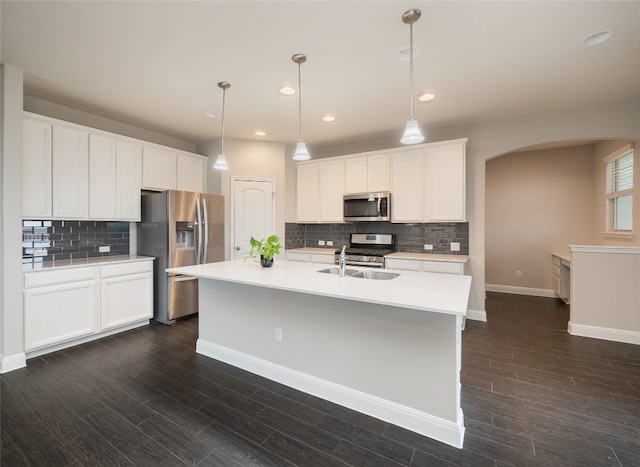 237 Andele Way, Liberty Hill, TX 78642 - kitchen with appliances with stainless steel finishes, a sink, arched walkways, tasteful backsplash, and light countertops