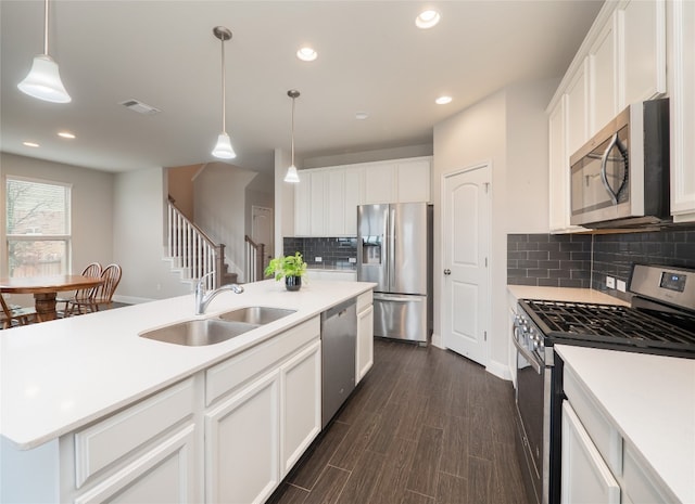 237 Andele Way, Liberty Hill, TX 78642 - kitchen with appliances with stainless steel finishes, a sink, decorative backsplash, light countertops, and white cabinets
