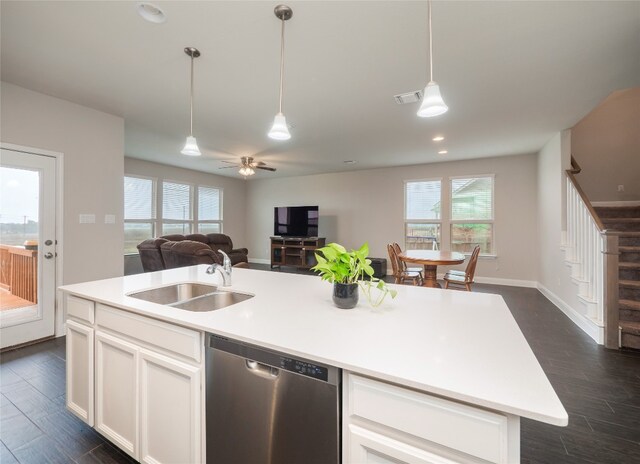 237 Andele Way, Liberty Hill, TX 78642 - kitchen featuring stainless steel dishwasher, a sink, open floor plan, white cabinets, and decorative light fixtures