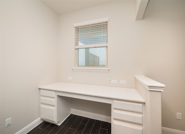 237 Andele Way, Liberty Hill, TX 78642 - unfurnished office with built in desk, baseboards, and wood finish floors