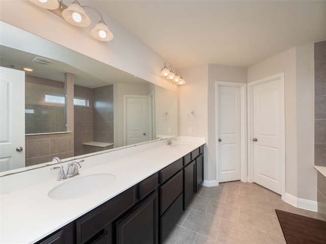 237 Andele Way, Liberty Hill, TX 78642 - bathroom with double vanity, baseboards, and tile patterned floors