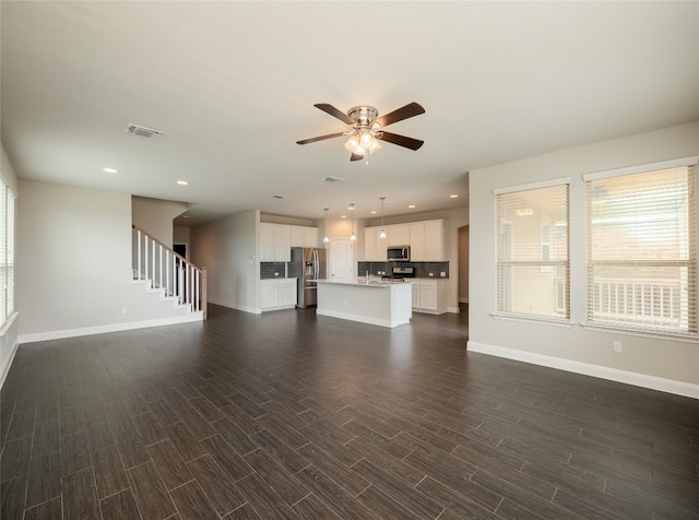 237 Andele Way, Liberty Hill, TX 78642 - unfurnished living room featuring ceiling fan, stairs, dark wood finished floors, and recessed lighting