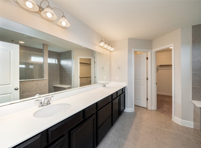 237 Andele Way, Liberty Hill, TX 78642 - full bath with a walk in closet, double vanity, and tile patterned flooring
