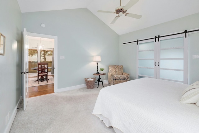 bedroom featuring high vaulted ceiling, a barn door, light carpet, and ceiling fan