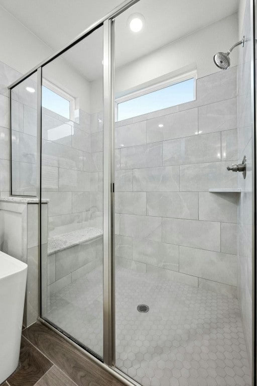 full bathroom with a stall shower and a freestanding tub