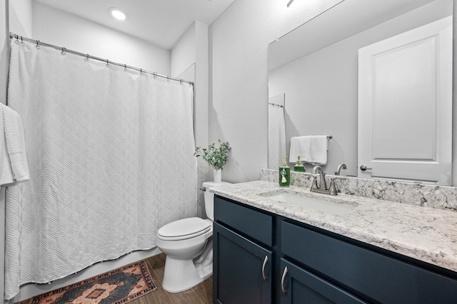 bathroom featuring hardwood / wood-style flooring, vanity, and toilet