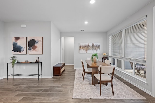 dining space with hardwood / wood-style flooring