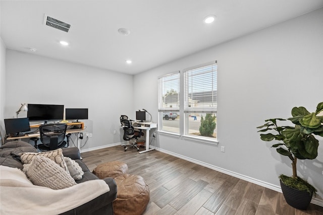 office area with recessed lighting, visible vents, baseboards, and wood finished floors