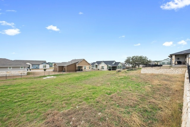 view of yard featuring a residential view and fence