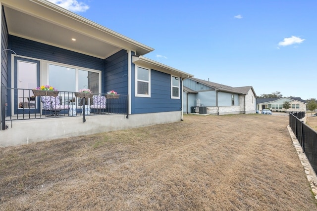 exterior space featuring central AC and fence