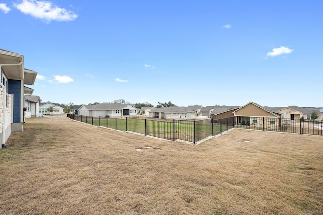 view of yard with a residential view and fence