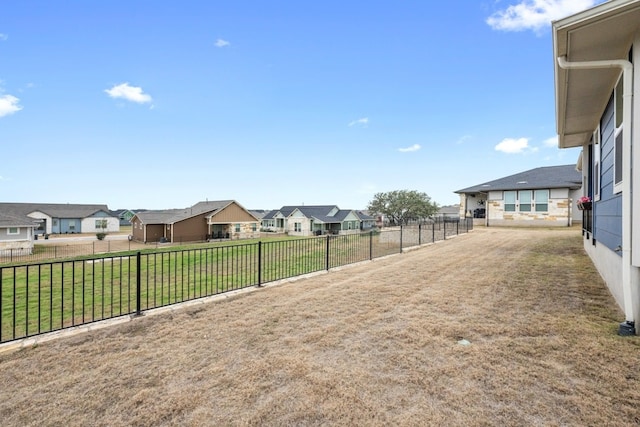 view of yard with a residential view and fence