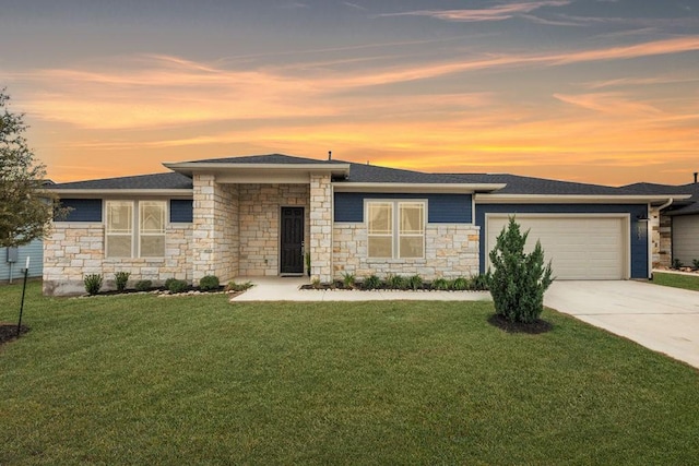 prairie-style house with a garage, a front lawn, and concrete driveway